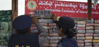 VOA - Myanmar police officers inspect seized drugs during a destruction ceremony of seized narcotic drugs on the outskirts of Yangon, Myanmar, Monday, June 26, 2017.